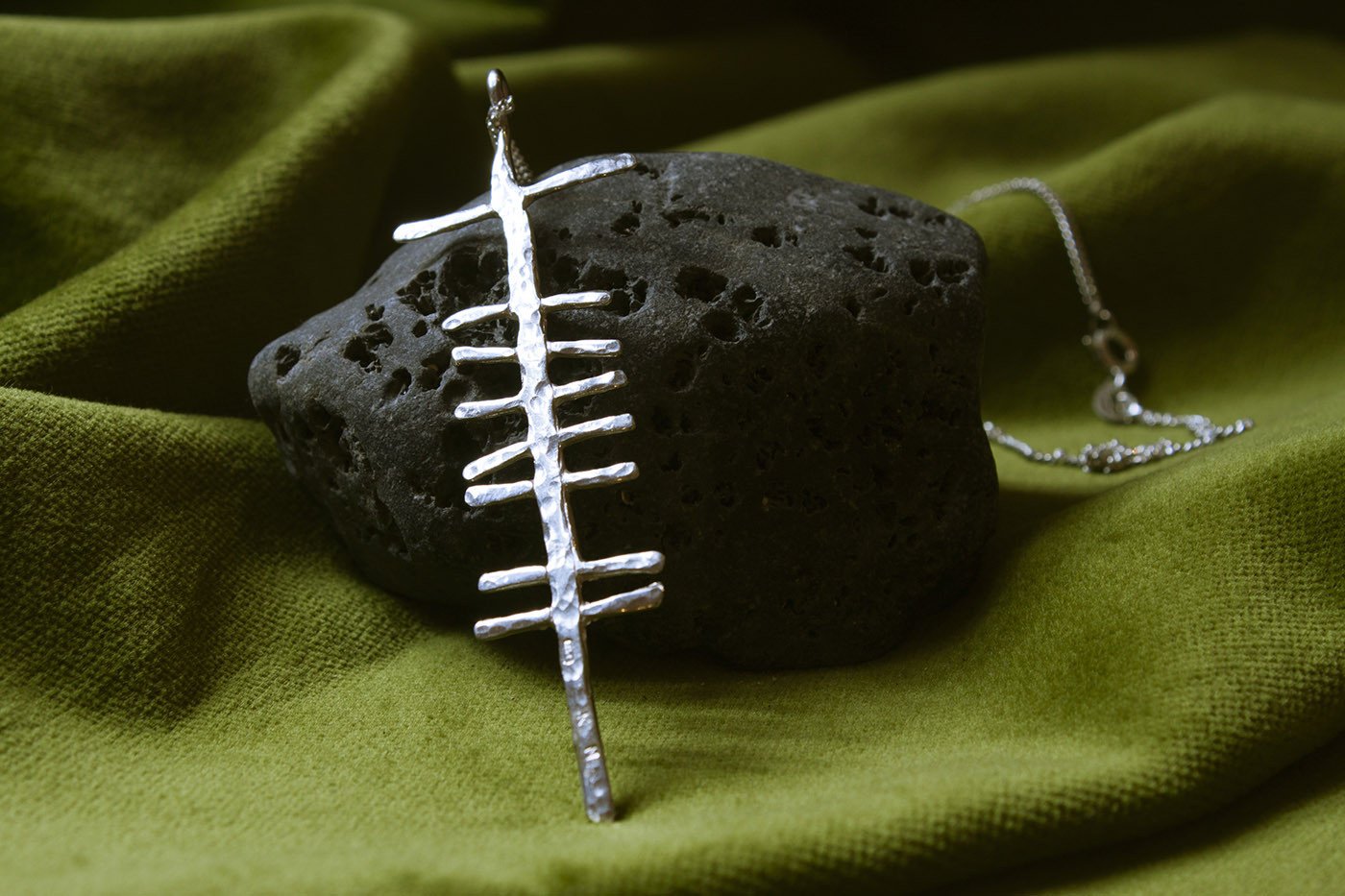 Love rustic silver pendant on a stone