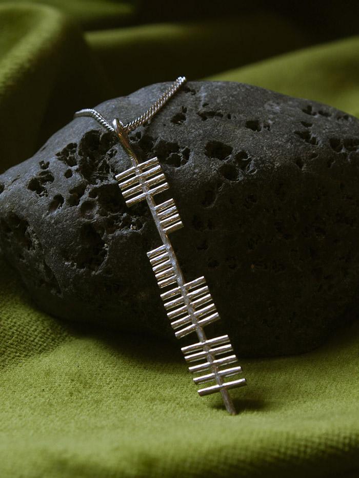 Dance silver pendant on a stone