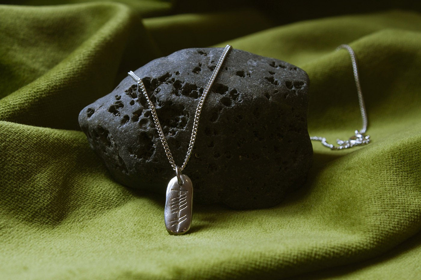 Love ingot silver pendant on a stone