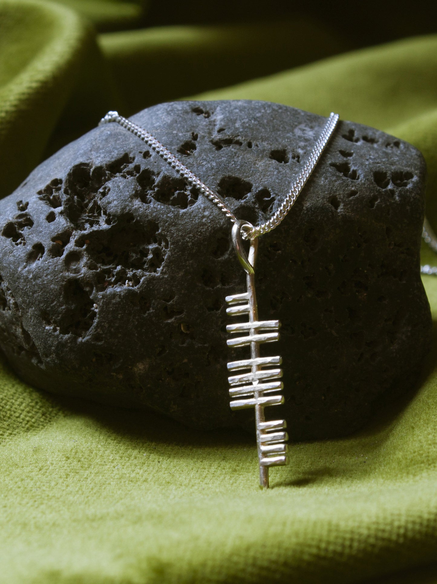 Music silver pendant on a stone